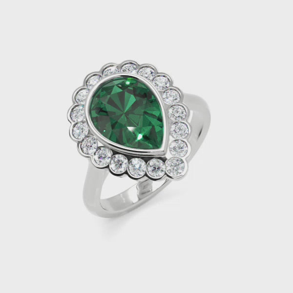Platinum pear shaped emerald & diamond cluster ring