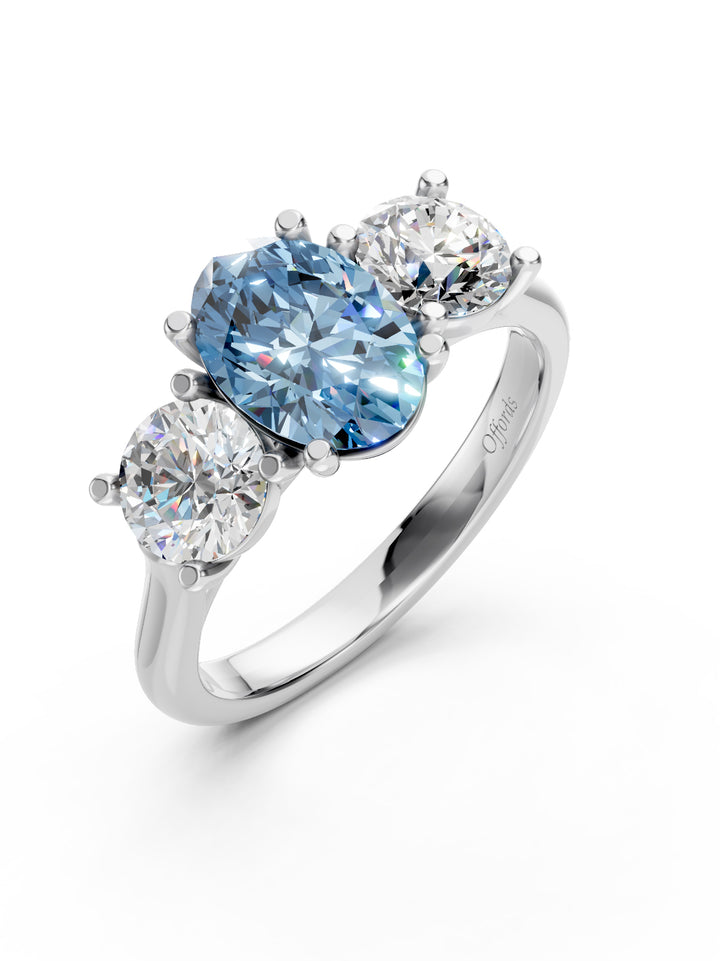 Platinum laboratory grown fancy vivd blue diamond oval three stone ring