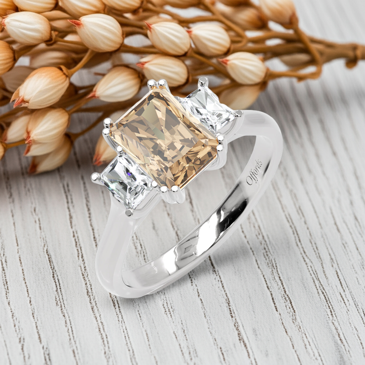 Platinum peach sapphire & diamond three stone ring